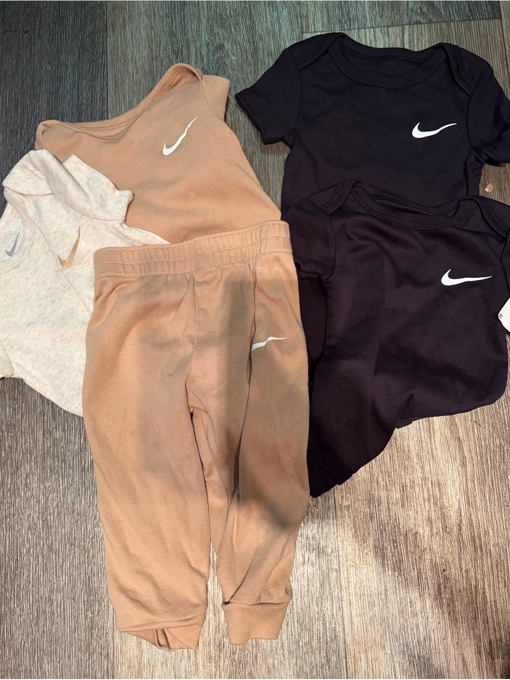 Nike Kids black and tan onesies with 1 pair of tan pants.